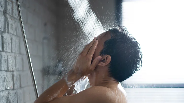 man in shower washing face 1303774341 - Fit Kilter